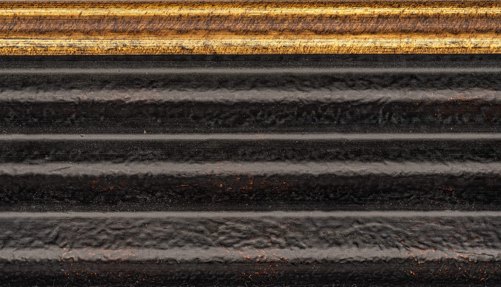 Carved Obsidian — ribbed dark wood with gold trim